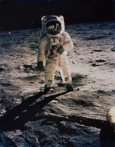 Buzz Aldrin on the Moon with Scene Reflected in his Face Covering and Footprints on Ground