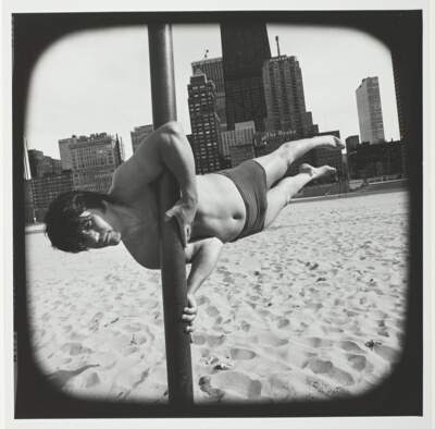 Untitled (Man in Bathing Suit Balancing Himself on Pole Vertical to the Sand), from the series "Beach"