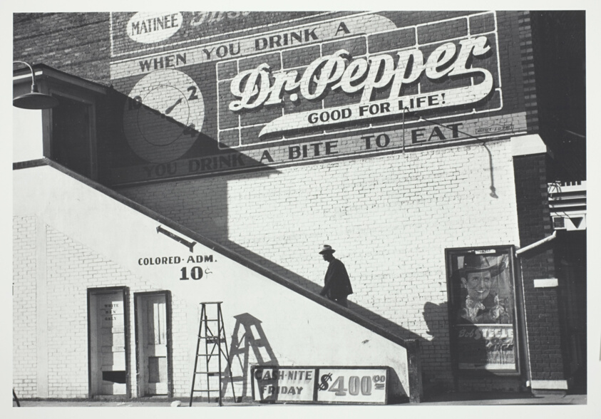 Negro man entering a movie theatre by outside stairway "For Colored Only" in the Delta area, Belzoni, Mississippi