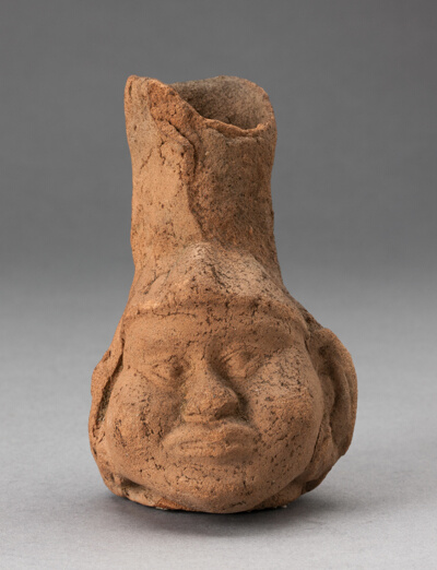Heavily Eroded Miniature Jar in Form of a Human Head with Large Cheeks