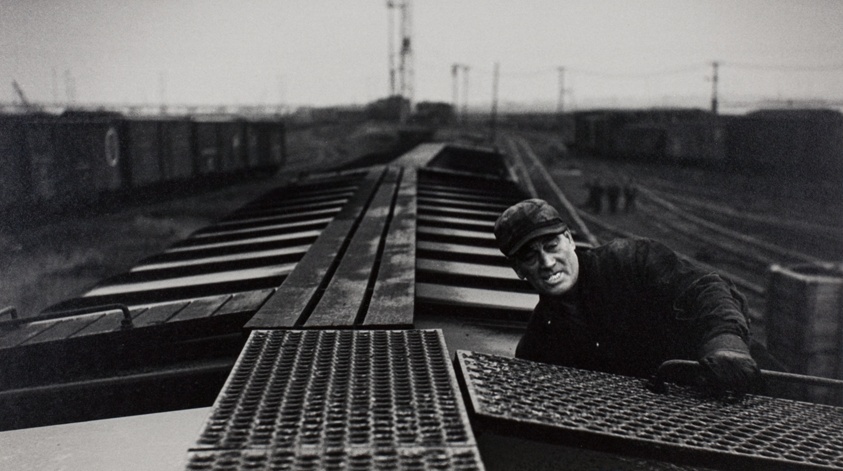 A Brakeman Rides a String of Cars Down the Hump