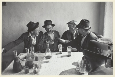 Men Seated Around a Table Drinking Wine
