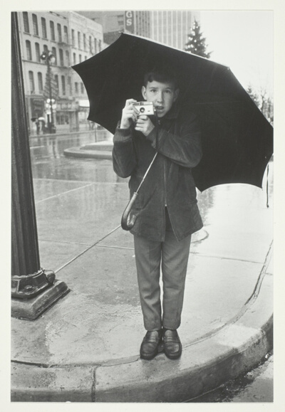 Boy with Instamatic in the Rain