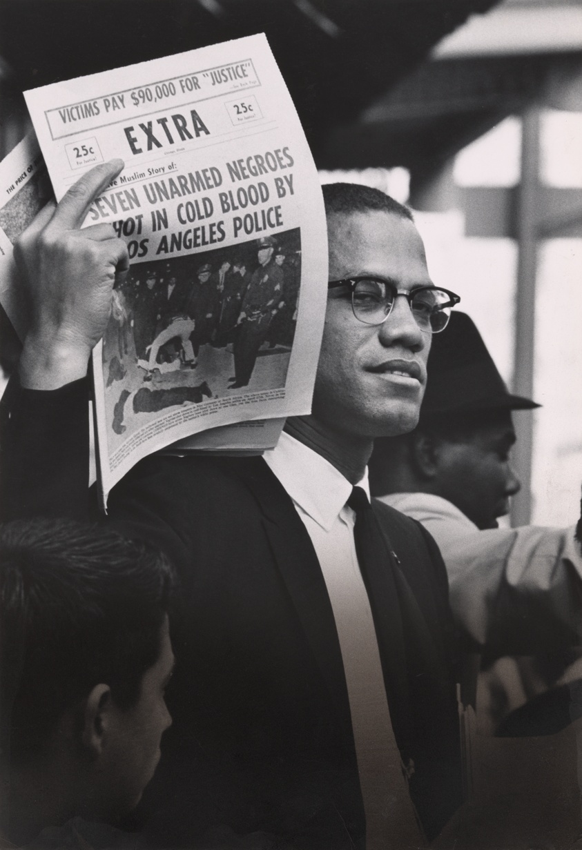 Malcolm X Holding up Black Muslim Newspaper, Los Angeles, California