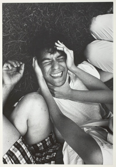 Boy laughing; Face Squeezed by Girls' Hands