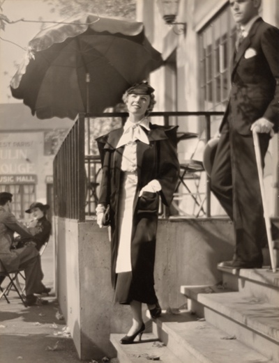 Fashion photograph: Woman in White Gloves Descending Stairs with One Hand in Pocket