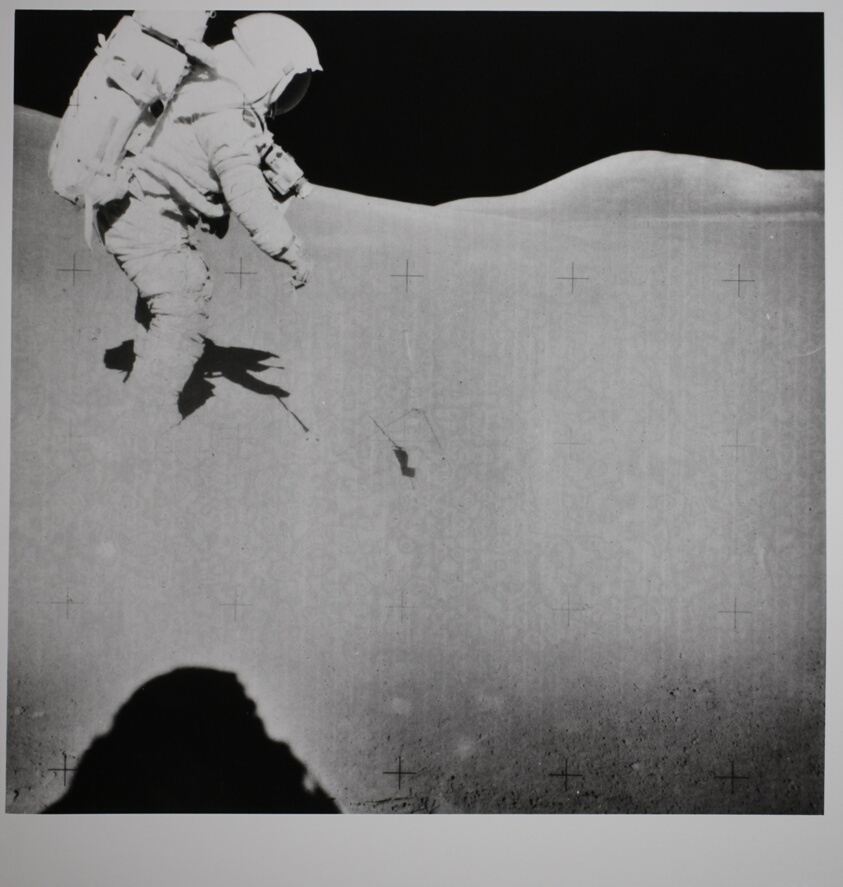 Untitled (David R. Scott gathering lunar regolith samples while conducting senelogical experiments on the Moon, with Iriwn’s Shadow in the Left Foreground)