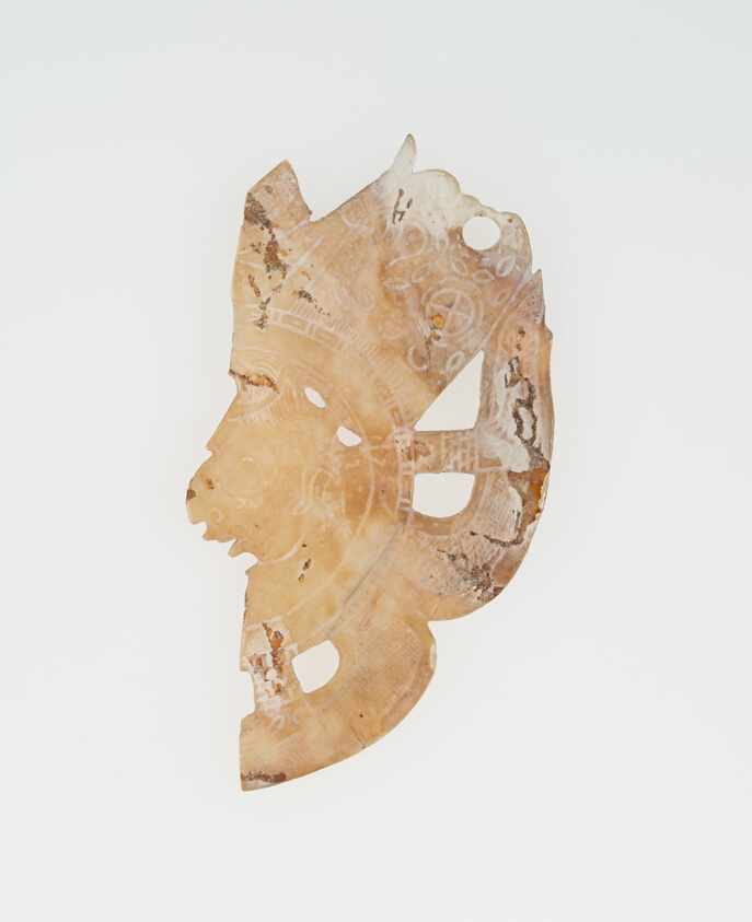 Carved Shell Depicting the Profile Face of Diety (Broken)
