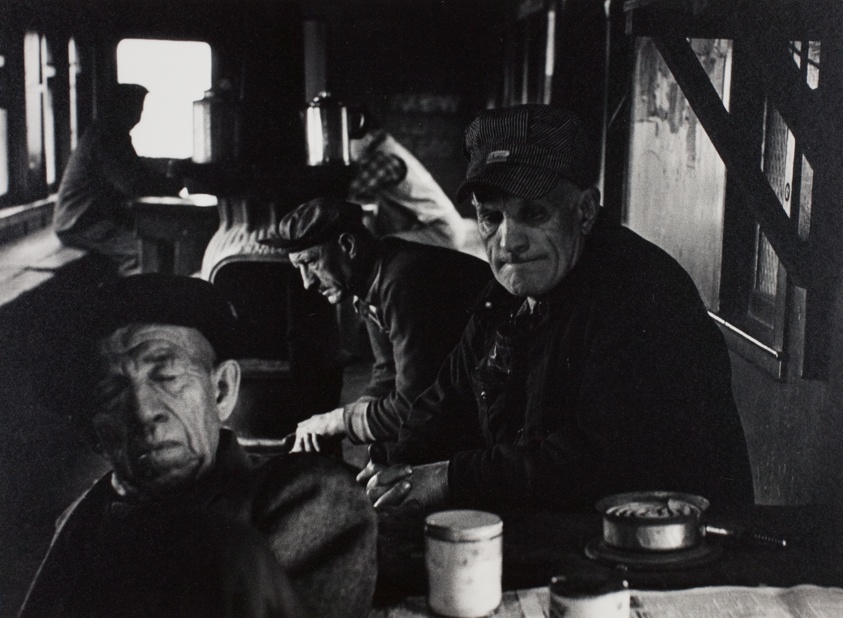 A Yard Crew Keeps Warm and Waits Between Jobs in a Converted Car in the Yard, No. 6 from the portfolio "Railroad Men"