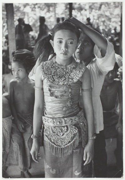 Girl Standing Patiently While Hair is Arranged, Indonesia